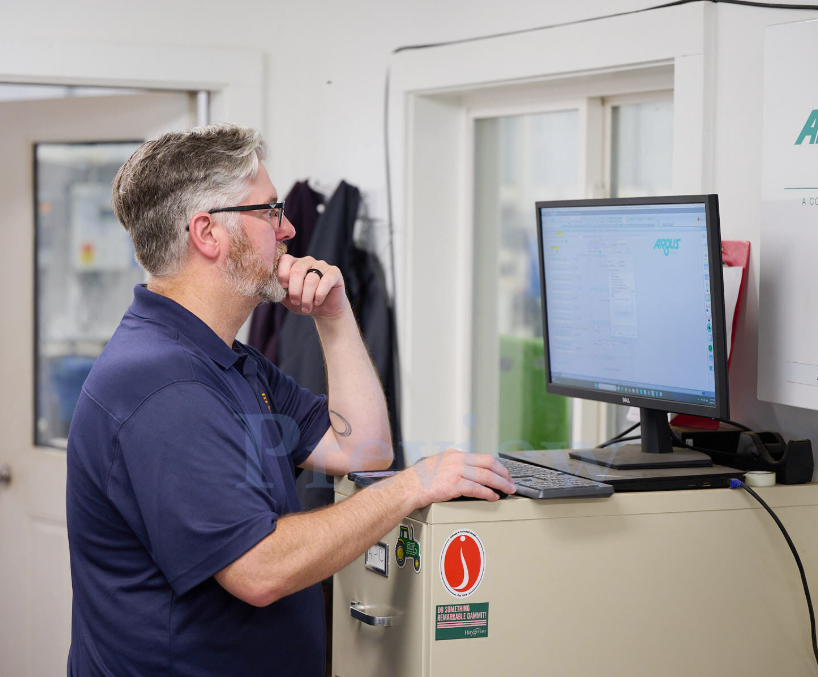TC Controls programmer reviewing controls logic on the Argus software workstation