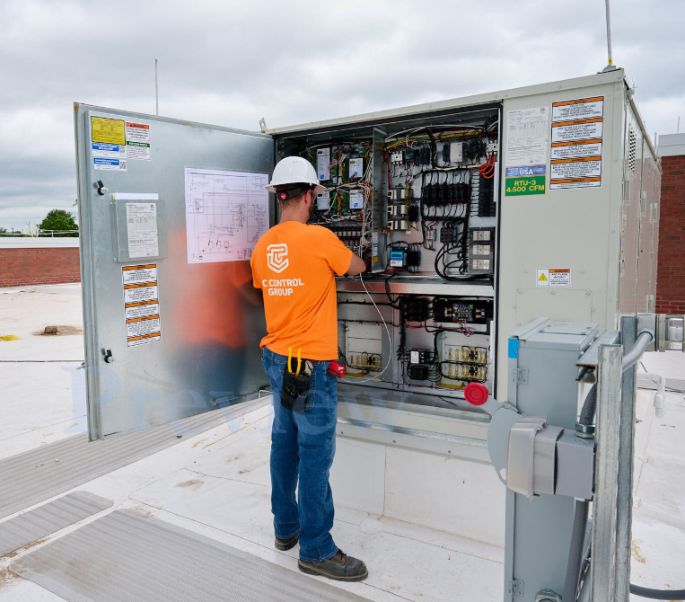 TC Controls technician installing controls on a rooftop HVAC unit at the Springfield office building